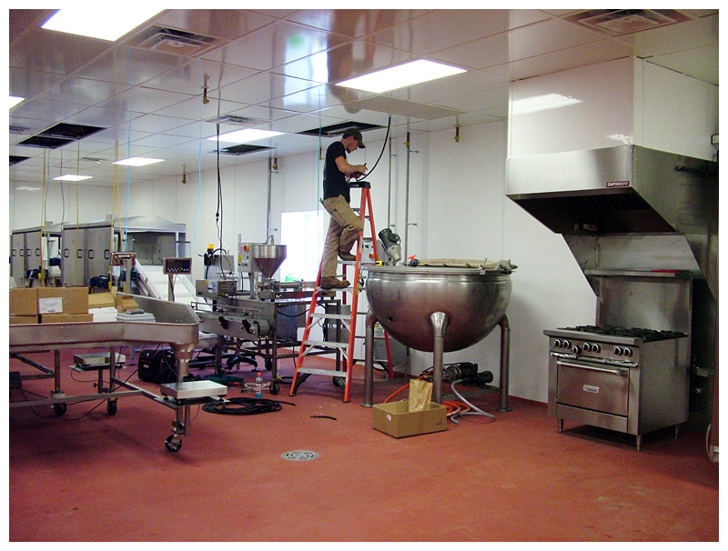 Ryan St. Clair of Arc Electric installs drop cords in the commercial kitchen in January. (Photo by Ethan Andrews)