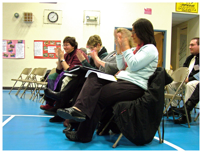 Four representatives of the RSU 20 teachers' union react after the vote by the school board to ratify a new contract for 2012-2014. (Photo by Ethan Andrews)