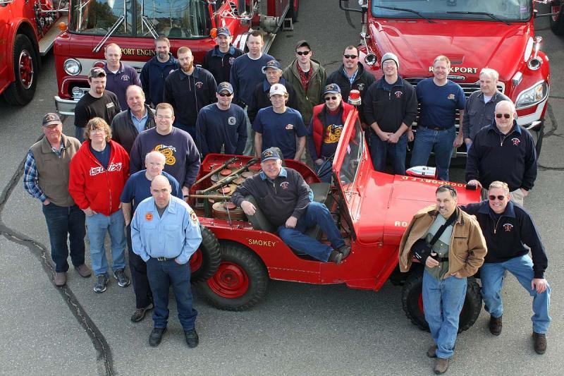 A photo of current, active Rockport firefighters with Chief Bruce Woodward seated in the Jeep. (Photo by Holly S. Edwards)