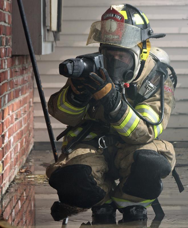 Camden Fire Lt. Scott 'Sparky' Entwistle uses a thermal imaging camera to check for hot spots. (Photo by Holly S. Edwards)