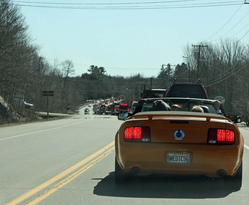 Riding in a bright orange Mustang, Fire Chief Bruce Woodward and his family follow the parade down Route 1 toward the Samoset Resort, near the Rockland town line. (Photo by Holly S. Edwards)