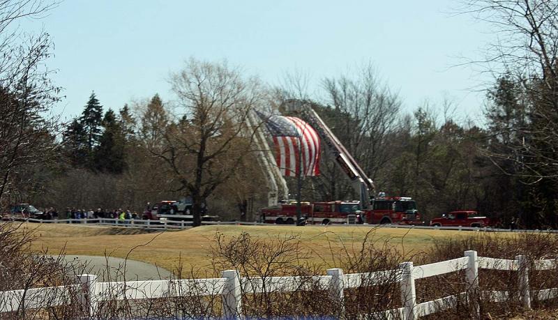 Camden's and Rockland's ladder trucks set up with a giant American flag for everyone to drive under entering the Samoset property Saturday. (Photo by Holly S. Edwards)