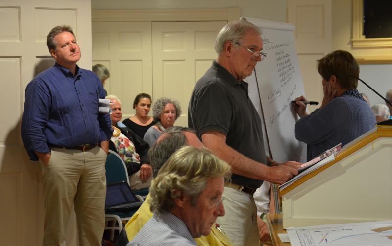 Rockport resident Jim Ruddy questions the Rockport Library Committee and Select Board on the reasoning behind the idea of building a new Rockport Public Library on the former Rockport Elementary School site on West Street at a workshop July 23. (Photo by Lynda Clancy)