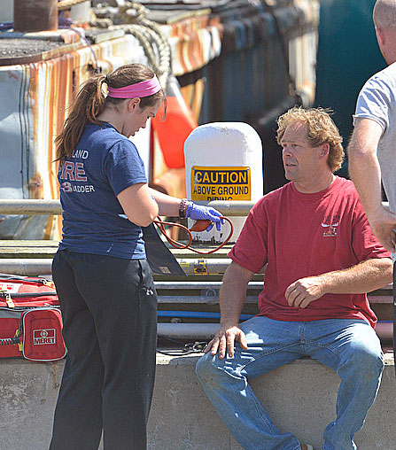 Another uninjured crewman, who helped rescue the two injured men, is checked by medical personnel after Friday’s accident aboard ‘Starlight.’ (Photo by Ron Hawkes)