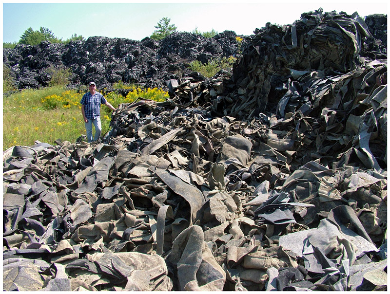 A portion of the largest piles of scrap fiber material on the former shooting range. (Photo by Ethan Andrews)