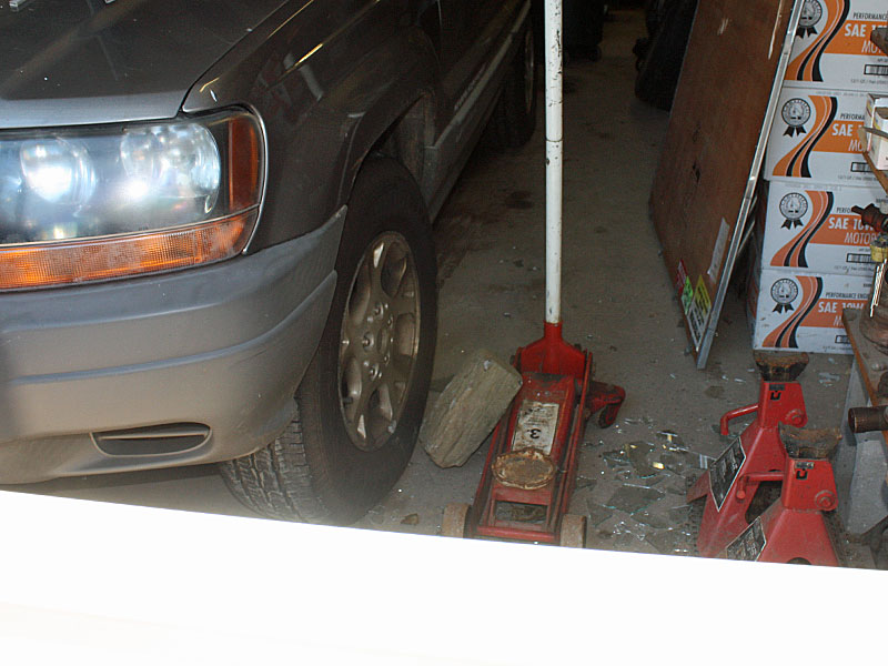 The rock used to break through the garage bay window at Camden Exxon overnight Saturday lies on the floor. Owner Steve Laite and his family were at the business Sunday morning cleaning up broken glass, boarding up windows and picking up paperwork, customer keys and family mementos strewn about by the burglars who turned to vandalism when they didn't find what they were looking for -- inspection stickers. (Photo by Holly S. Edwards)