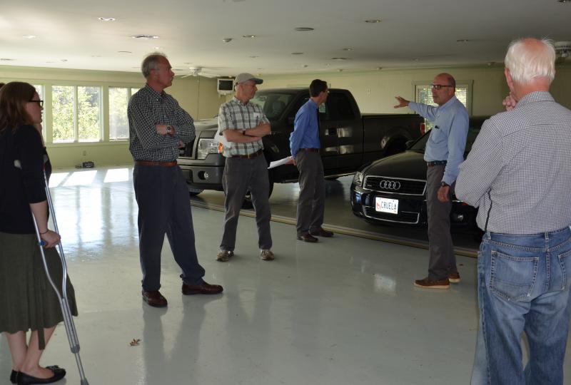 Camden Planning Board members in the Fox Hill garage that would become a gym, if the project is approved. Members here are Kim Tuttle, Lowrie Sargent, John Scholz, with Pierce Atwood Attorney Matthew Manahan, Fox Hill Real Estate principal Tom Rodman, and Planning Board member Richard Bernhard. (Photo by Lynda Clancy)