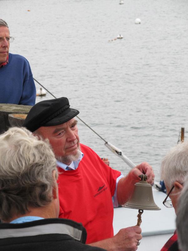Jim Barstow rings the bell for the blessing of the fleet. (Photo by Kay Stephens)