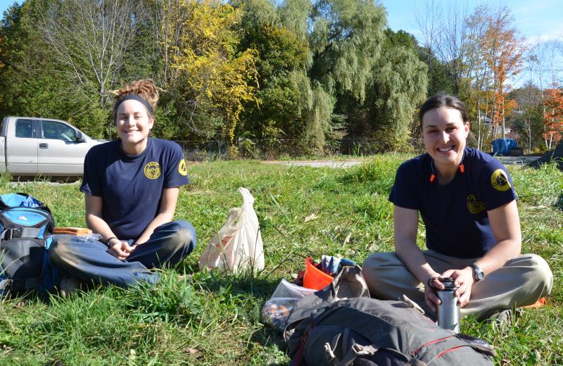 Amie Daniels, of Lewiston, and Savannah Steele, of Gray, are Maine Conservation Corps employees on site at the former Apollo Tannery to build a section of the Megunticook Riverwalk. (Photo by Lynda Clancy)