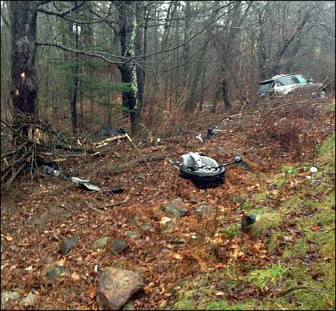 Debris left behind Cameron Dow’s 2014 Land Rover Ranger after it crashed on Alford Lake Road in Hope Wednesday afternoon. (Courtesy Rockport Fire Department)