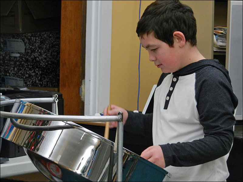 Max plays a Christmas song on a steel drum. (Photo by Eva Murray)