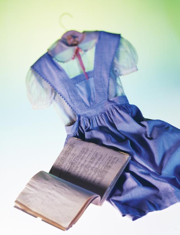 A Gilbert Adrian-designed dress tested by Judy Garland for "The Wizard of Oz" (1939) and the blouse she wore during the first two weeks of filming, together with a shooting script used by Bobby Connolly, who staged the dance numbers. Courtesy of "The Wonderful World of Oz: An Illustrated History of the American Classic" by John Fricke (Down East Books). "Dorothy's" dress, shooting script