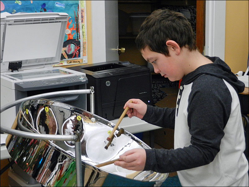 Another photo of Max playing the steel drum. (Photo by Eva Murray)