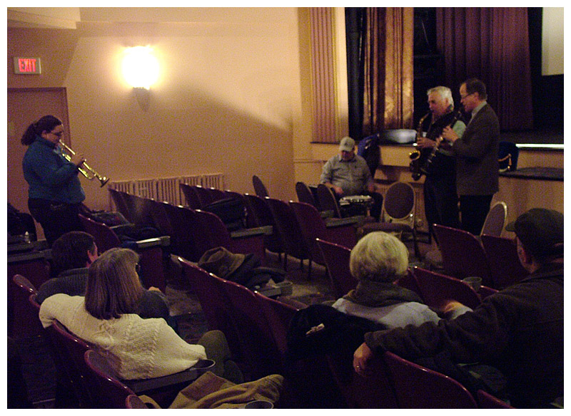 Several musicians, including Maylinda Boynton, standing, left, Alan Crichton and Dan Kirchoff test the waters on the new band idea. Others pictured did not bring instruments to the informational meeting at the Colonial Theatre, Monday night. (Photo by Ethan Andrews)