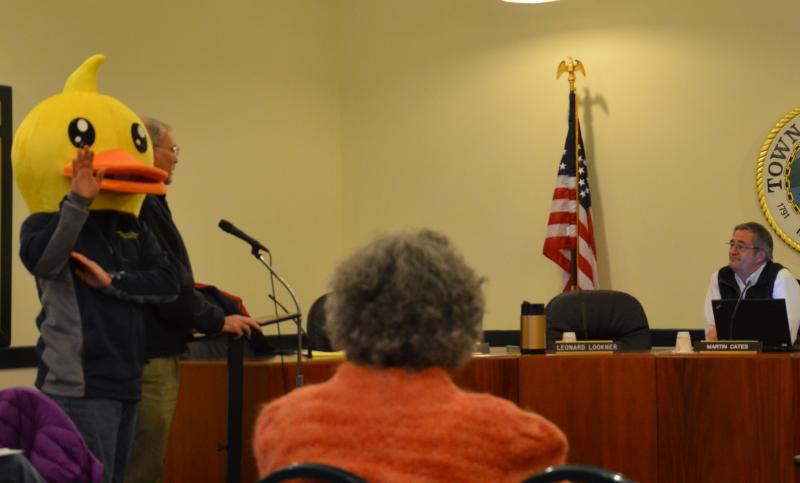 Peter Burke, AKA Yellow Duck, and fellow Rotarian ask the Camden Select Board for permission to use the Megunticook River and upper Camden Harbor to float ducks during the West Bay Rotary’s annual Duck Derby, Saturday, May 31. (Photo by Lynda Clancy)