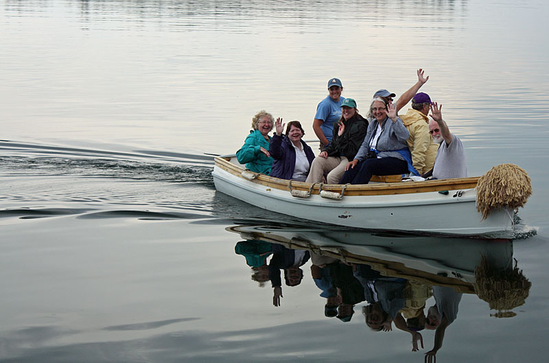 Schooner Mary Day passengers return to the boat Wednesday after going ashore in Brooklin to visit the Wooden Boat School. (Photo by Holly S. Edwards)