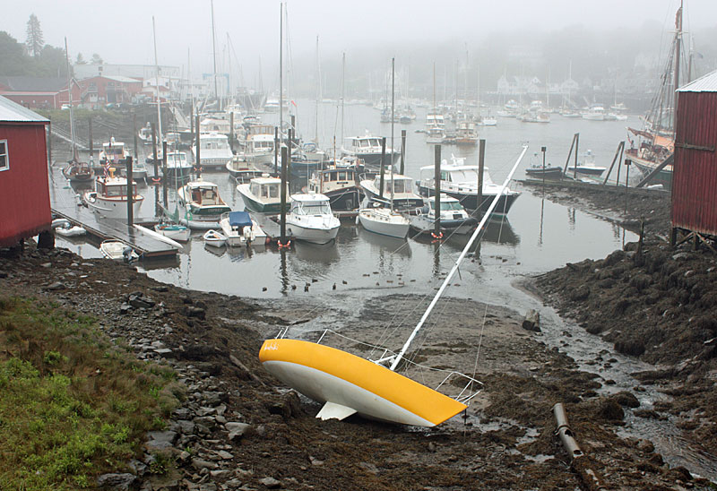 The Kohiki came to rest between the two boat barns at the head of Camden Harbor, after it made passage through the inner harbor channel from its mooring off Dillingham Point. (Photo by Holly S. Edwards)