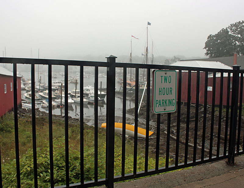 The boat, which escaped damage without even a scratch, will remain where it came to rest last night until high tide, when the incoming waters will lift it and right it, and allow it to be towed back out into the harbor. (Photo by Holly S. Edwards)