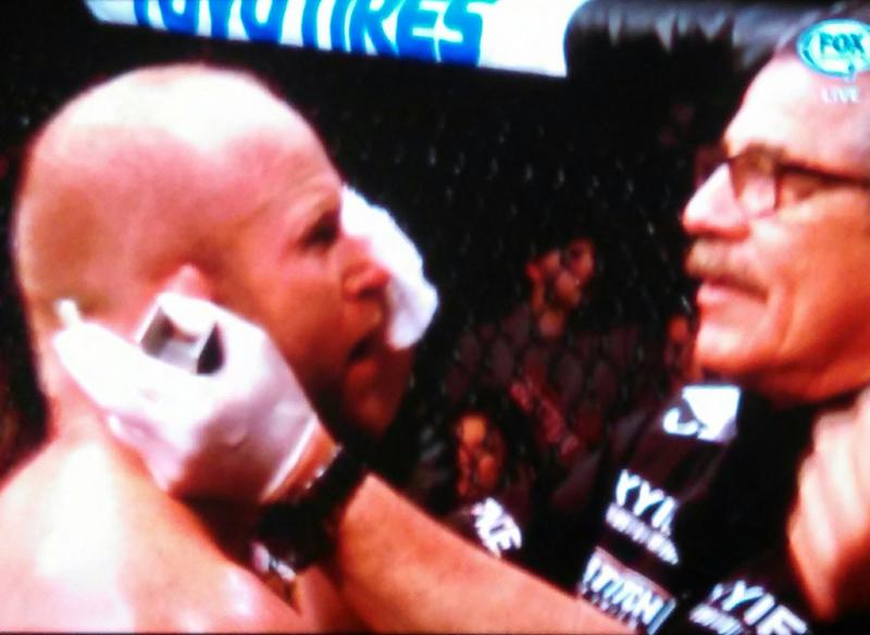 Tim Boetsch gets some blood wiped off his face. (Photo by George Harvey)