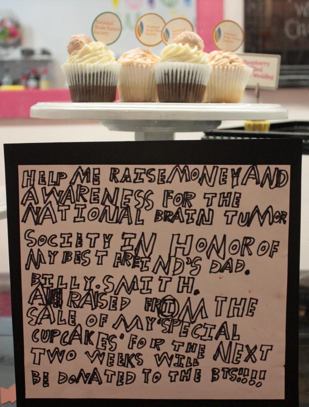 Jacob Murray spent a long afternoon writing, and rewriting, this sign to announce his Brain Cupcake fundraiser two weeks ago. (Photo by Holly S. Edwards)