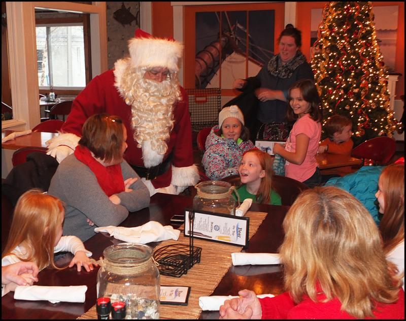 Santa Claus engages children at breakfast Sunday morning at the Chowder House.