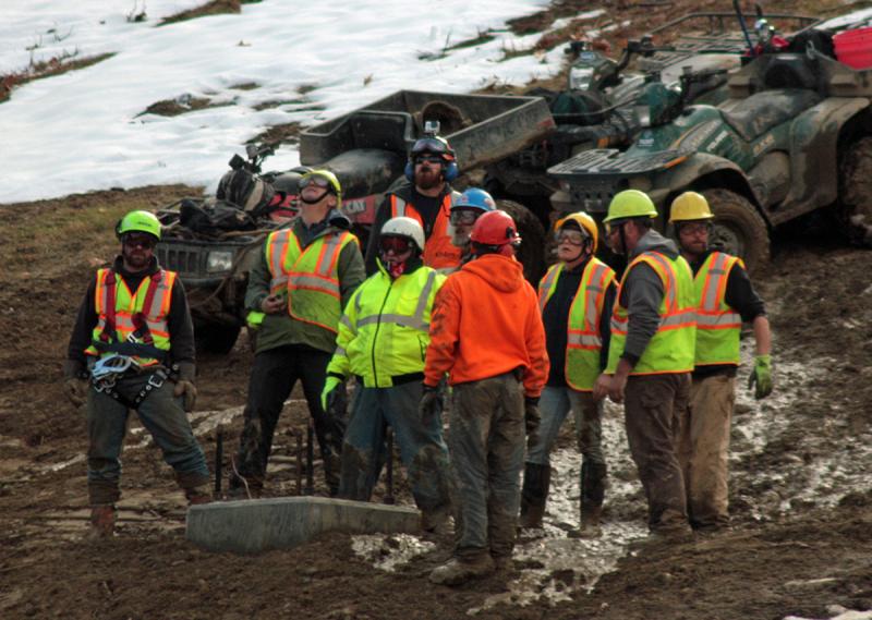 The crew on the mountain waits and watches for the next tower to arrive, via helicopter. (Photo by Holly S. Edwards)