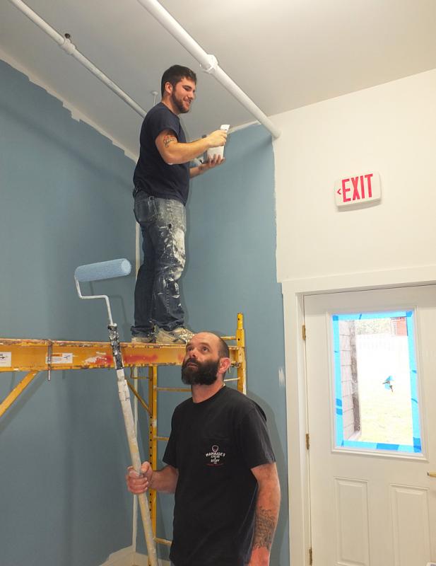 Jason Booth and Gary Arsenalp work to prepare the building.