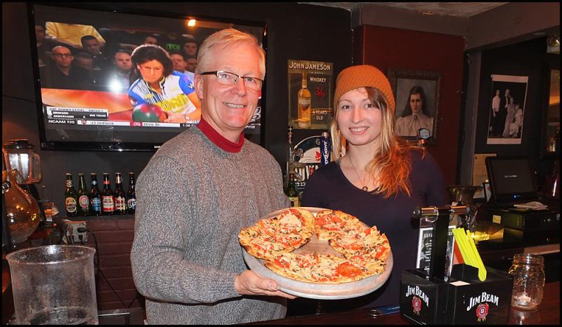 Kevin LaBree and Tegan Walsh serve up BBQ chicken at the Chowder House Speakeasy. (Photo by Chris Wolf)