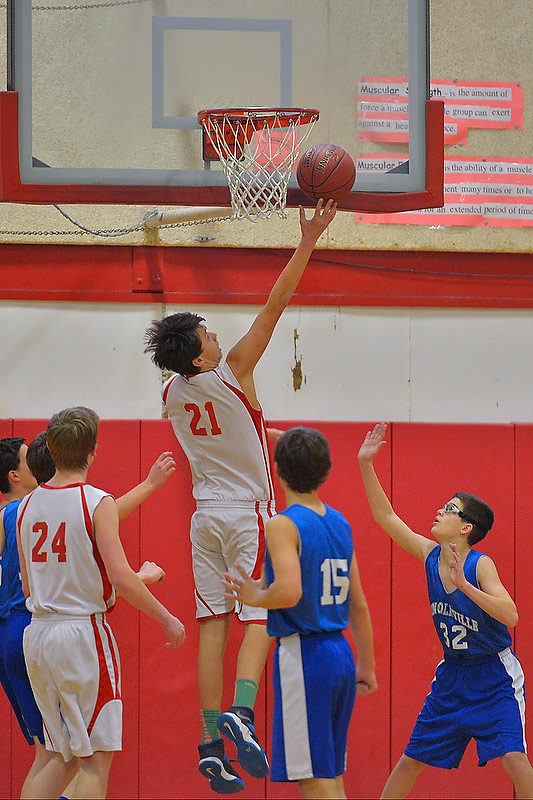 Camden’s Jack Hanson, center, goes high up over everyone with a shot in Monday’s game. Hanson led his team with 20 points. (Photo by Ron Hawkes)