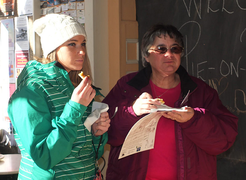 Melissa Burgess and Lisa Burgess, of Rockland, enjoy a bite of Thorndike Creamery pizza. Both are from Rockland and both are enjoying their first Pies on Parade. (Photo by Chris Wolf)