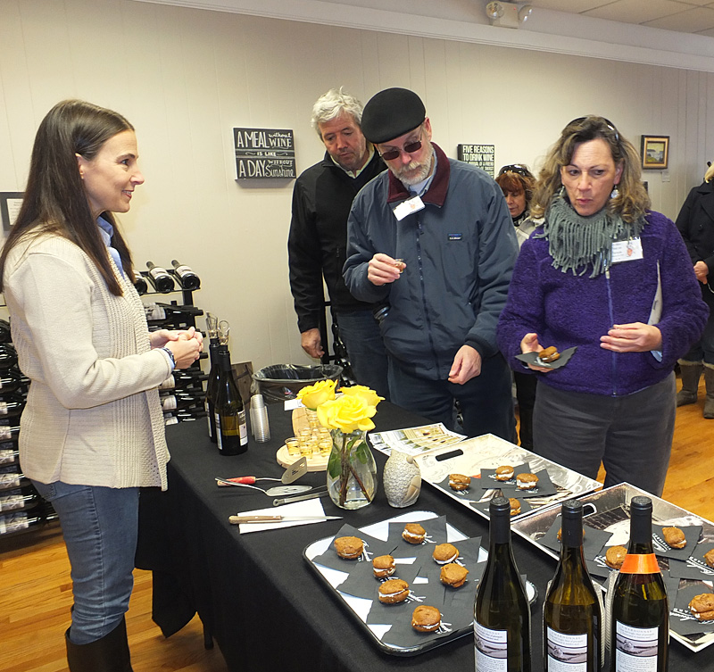 Breakwater Vineyards: Lisa Dickson behind table with Lyne Cayting and Garry Hinkley in front. (Photo by Chris Wolf)