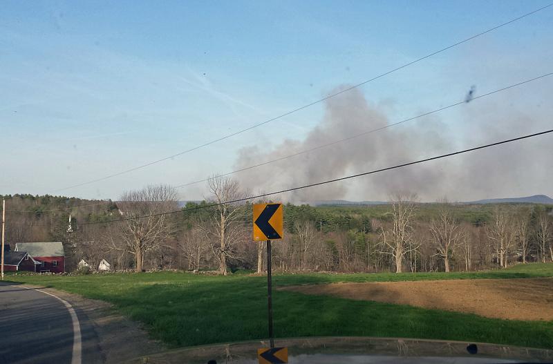 Firefighters from Searsmont, Liberty, Montville and Morrill spent late Thursday afternoon and early evening battling a large woods fire in Searsmont, with assistance from two Maine Forest Service helicopters. (Courtesy Bob Hall)