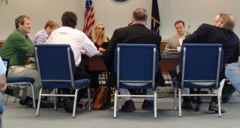 RSU 13 Business Manager Peter Orne (in green shirt), Vice Chair Loren Andrews, Superintendent John McDonald, and Chair Steve Roberts face Rockland City Councilors Will Clayton, Louise MacLellan-Ruf, and City Manager James Chaousis II.