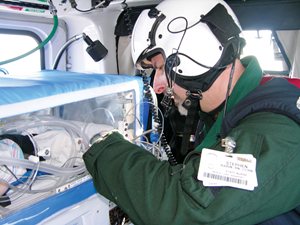 Unidentified LifeFlight crew member and an isolette. (Photo courtesy of LifeFlight of Maine)