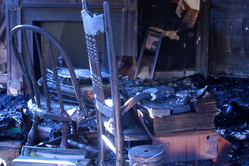 Family photo albums and other books are among the few possessions current and future generations of the Martin family might be able to retain after fire destroyed their ancestral home in Warren Sunday night. (Photo by Holly S. Edwards)