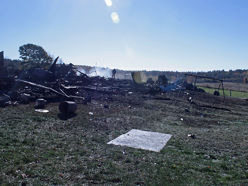 Alan Martin surveys what used to be the barn. (Photo by Holly S. Edwards)