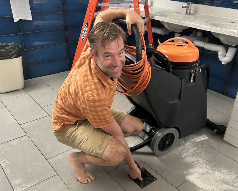 CRMS Principal Jacob Giessman rolls up his sleeves to help with the cleanup. (Photo courtesy SAD 28) c