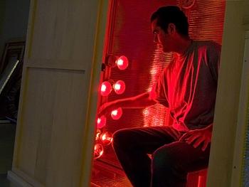 Michael Goldstein sits inside a partially completed near infrared sauna he built at the Searsport workshop of his one-man company Long Life Saunas. (Photo by Ethan Andrews)