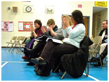 Four representatives of the RSU 20 teachers' union react after the vote by the school board to ratify a new contract for 2012-2014. (Photo by Ethan Andrews)