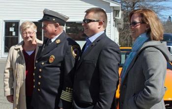 From left, Jennifer and Bruce Woodward watch the parade with their son, Andy, and his wife, Amy. (Photo by Holly S. Edwards)