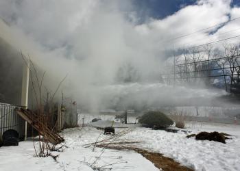Using a stream of water to vent smoke out of the building. (Photo by Holly S. Edwards)
