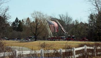 Camden's and Rockland's ladder trucks set up with a giant American flag for everyone to drive under entering the Samoset property Saturday. (Photo by Holly S. Edwards)