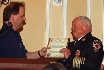 Hope Fire Chief Clarence Keller hands a plaque to Bruce Woodward, naming him Honorary Life Member of the Hope Volunteer Fire Department. (Photo by Holly S. Edwards)
