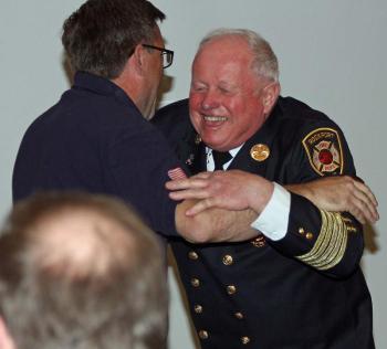 Lincolnville firefighter Mike Eugley just wanted a hug from Bruce Woodward, and he got it. So did many others Saturday. (Photo by Holly S. Edwards)