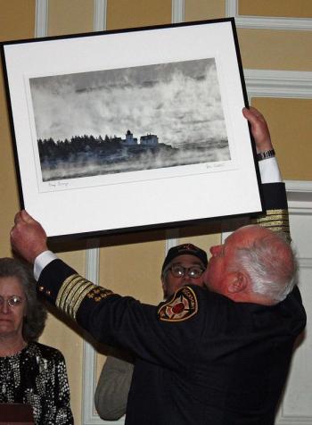 Fellow Rockport town employees gift a Peter Ralston photograph to Bruce Woodward. (Photo by Holly S. Edwards)