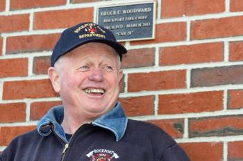 Bruce Woodward talks following breakfast Saturday morning at the fire station for past and present Rockport firefighters. Following breakfast, the plaque on the wall behind him was unveiled, honoring Bruce and "Car 20," his radio identification and red pickup truck's license plate. (Photo by Holly S. Edwards)
