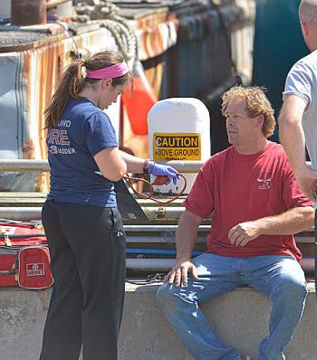Another uninjured crewman, who helped rescue the two injured men, is checked by medical personnel after Friday’s accident aboard ‘Starlight.’ (Photo by Ron Hawkes)