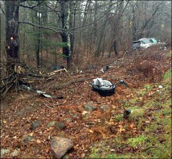 Debris left behind Cameron Dow’s 2014 Land Rover Ranger after it crashed on Alford Lake Road in Hope Wednesday afternoon. (Courtesy Rockport Fire Department)