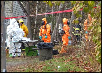 MDEA agents and members of the state DEP’s oil and hazardous material response team at the scene on South Shore Drive in Owls Head Friday. (Photo by Chris Wolf)