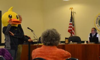 Peter Burke, AKA Yellow Duck, and fellow Rotarian ask the Camden Select Board for permission to use the Megunticook River and upper Camden Harbor to float ducks during the West Bay Rotary’s annual Duck Derby, Saturday, May 31. (Photo by Lynda Clancy)